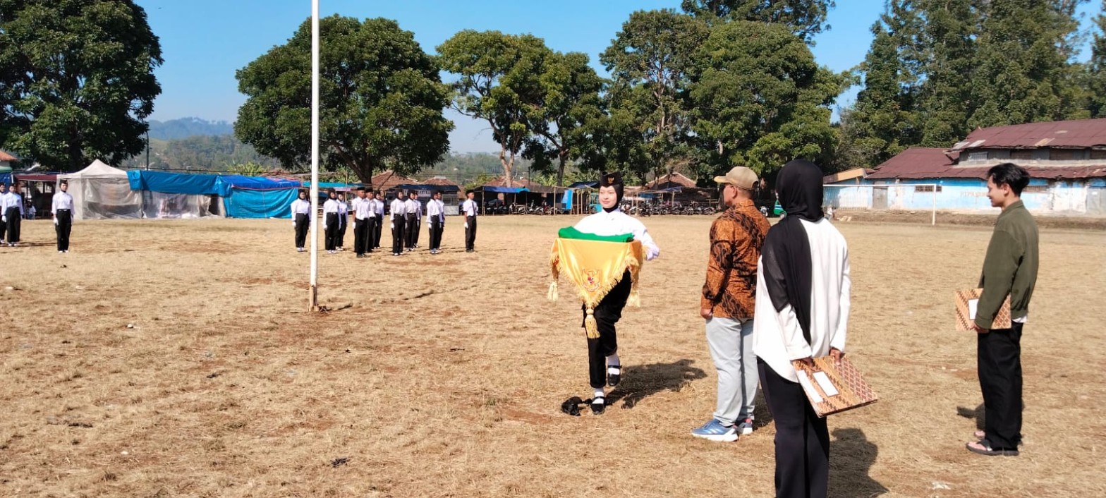 Siswi pembawa bendera pataka SMKN 1 Rongga berjalan tegap membawa bendera kuning hijau di hadapan pembimbing upacara