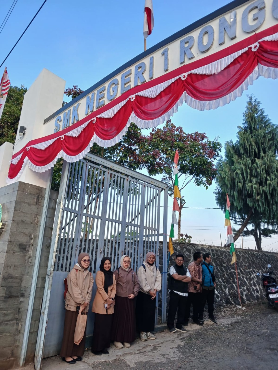 Guru-guru SMKN 1 Rongga berfoto bersama di depan gerbang sekolah yang dihias kain merah putih dan umbul-umbul