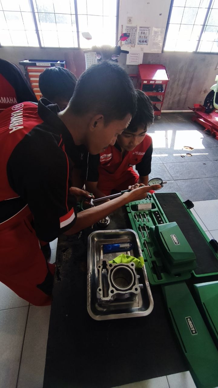 Dua siswa TSM SMKN 1 Rongga mengamati dengan cermat proses pengukuran diameter silinder menggunakan dial bore gauge