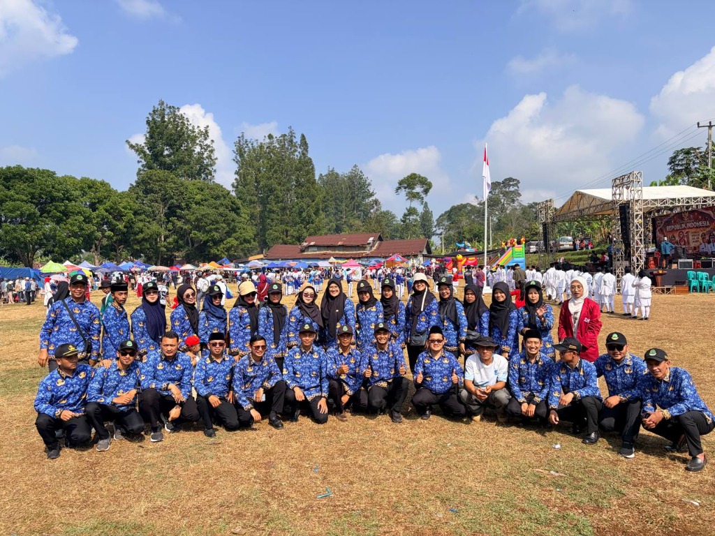 Foto bersama seluruh dewan guru dan tenaga kependidikan SMKN 1 Rongga berseragam KORPRI di tengah Lapangan Rongga dengan latar belakang panggung kehormatan HUT RI ke-81